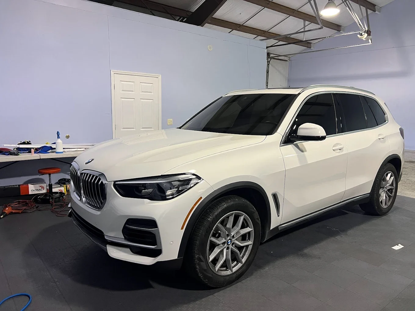 Technician carefully installing self-healing paint protection film