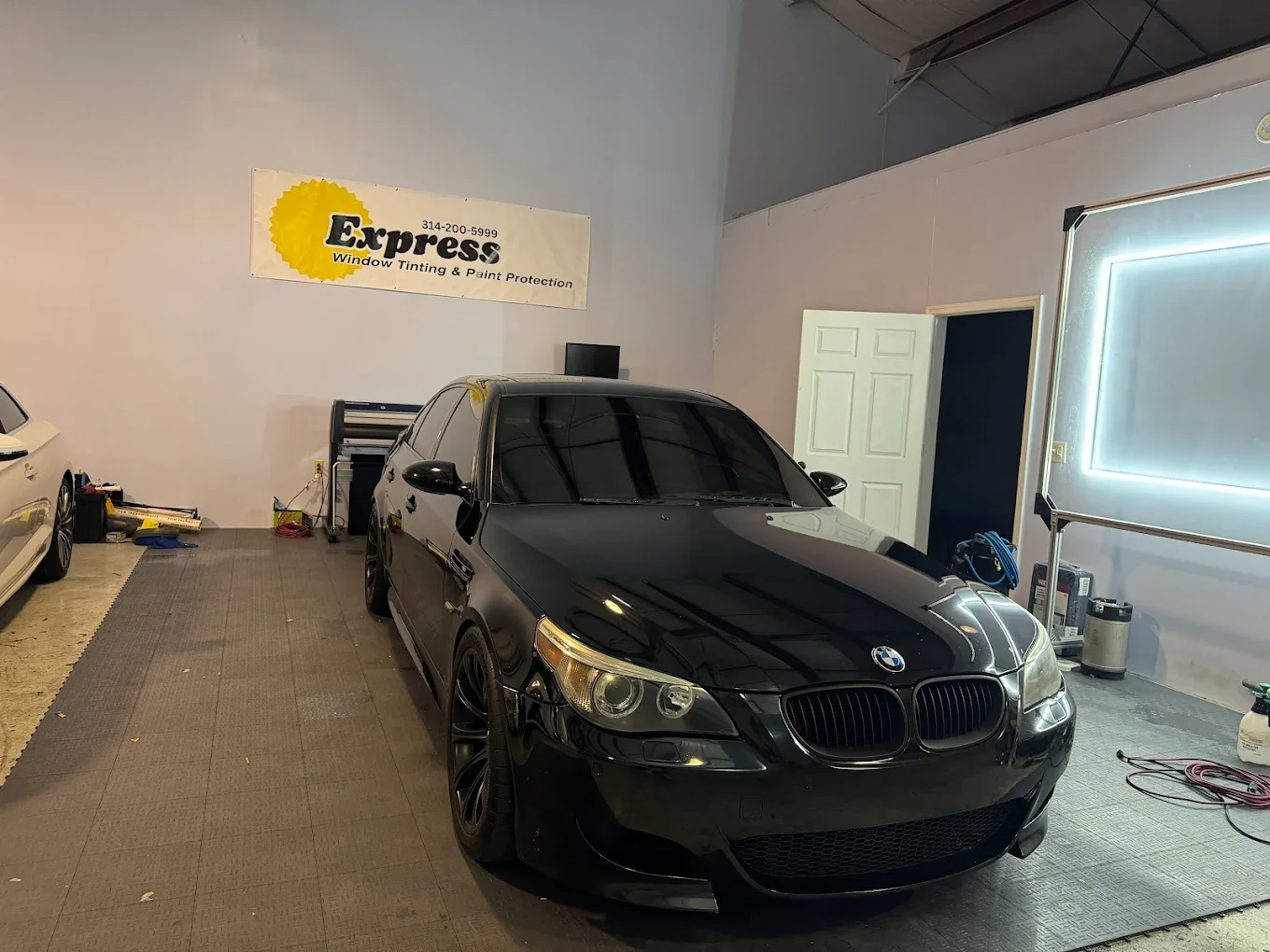 paint protection film to a car at Express Window Tinting in Creve Coeur, MO.